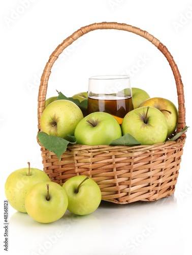 Photo: Useful apple juice with apples around in basket isolated Useful apple juice with apples around in basket isolated