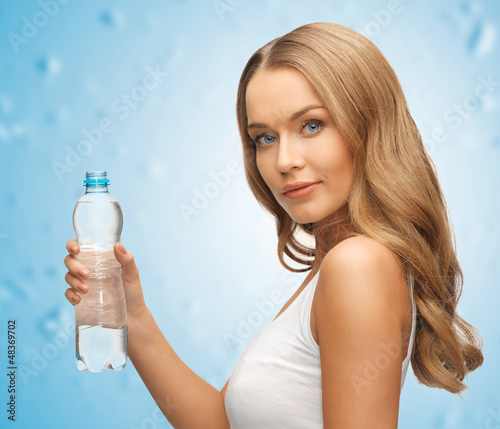 Photo: young beautiful woman with bottle of water young beautiful woman with bottle of water