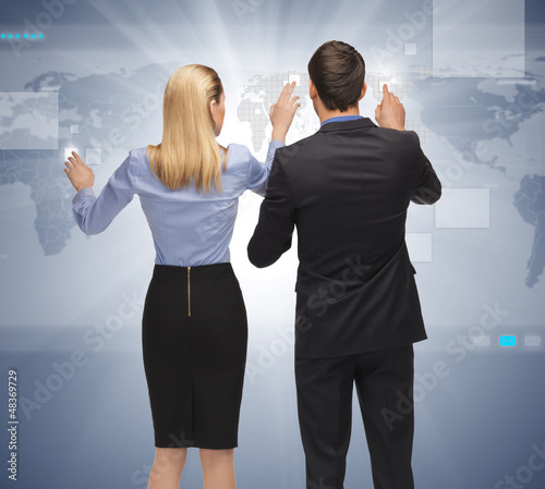 Photo: man and woman working with something imaginary man and woman working with something imaginary