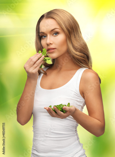 Photo: woman with spinach leaves on palms woman with spinach leaves on palms