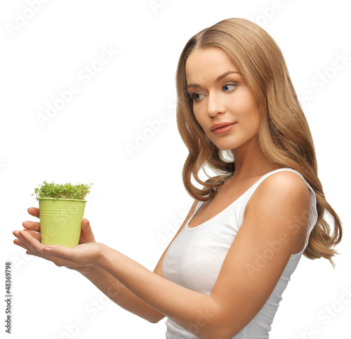 Photo: woman with green grass in pot woman with green grass in pot