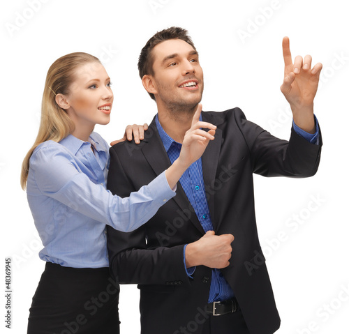 Photo: man and woman working with something imaginary man and woman working with something imaginary