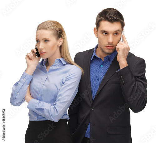 Photo: man and woman with cell phones man and woman with cell phones