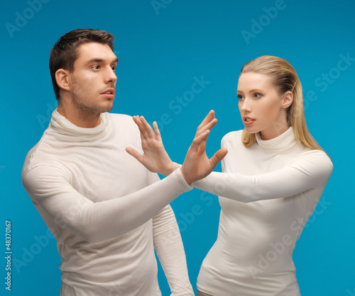 Photo: man and woman working with something imaginary man and woman working with something imaginary