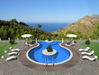 a terrace with swimming pool and beautiful view to the sea