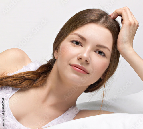 Photo: beautiful young woman in a bed beautiful young woman in a bed