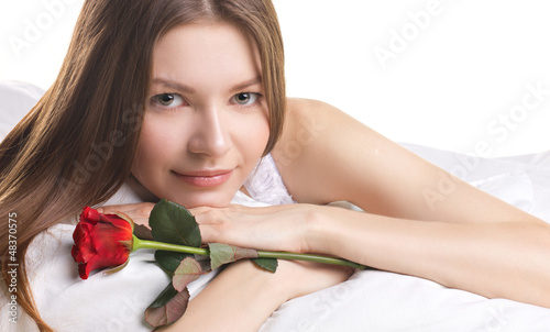 Photo: young woman with rose in a beg young woman with rose in a beg