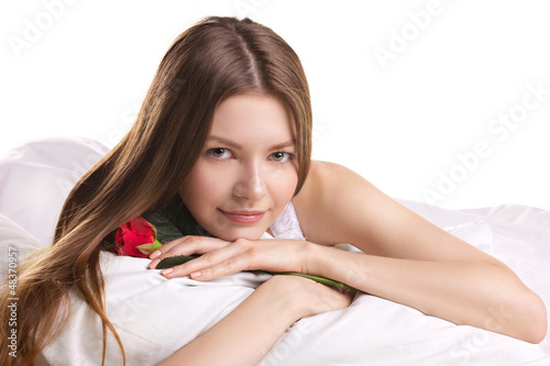 Photo: young woman with rose in a beg young woman with rose in a beg