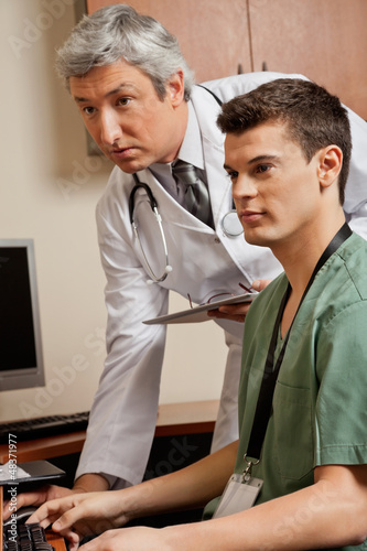 Photo: Doctor And Technician Working At Clinic Doctor And Technician Working At Clinic