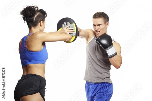 Photo: Young man and woman boxing sparring Young man and woman boxing sparring