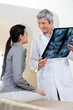Radiologist Looking At Female Patient