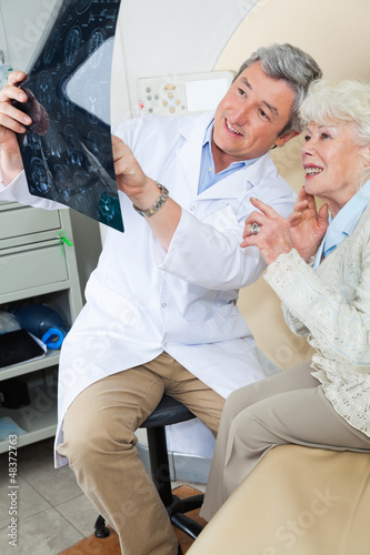 Photo: Radiologist Explaining X-ray To Patient Radiologist Explaining X-ray To Patient