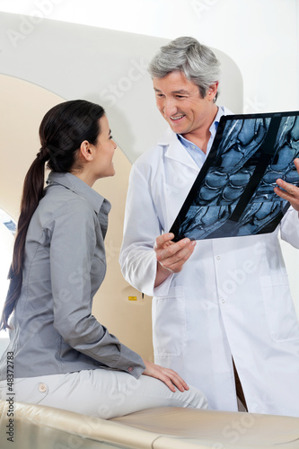 Photo: Radiologist Looking At Female Patient Radiologist Looking At Female Patient