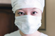 Photo: Close-up portrait of Chinese woman wearing a surgical mask. Close-up portrait of Chinese woman wearing a surgical mask.