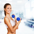 Dumbbell bicep curl by a fitness girl