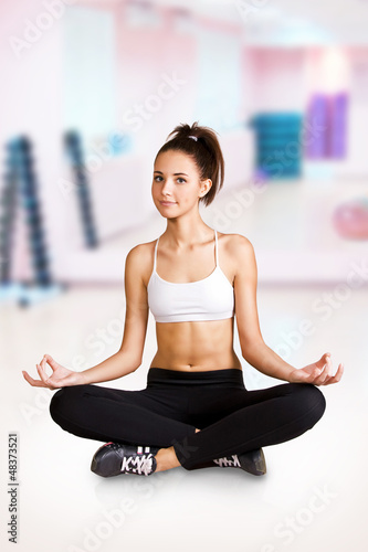 Photo: Fitness sport girl doing stretching exercise at the gym Fitness sport girl doing stretching exercise at the gym