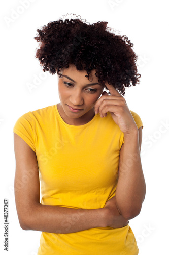 Photo: Calm and thoughtful curly haired young woman Calm and thoughtful curly haired young woman