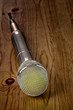 Microphone on wooden background