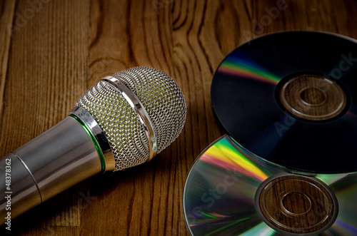 Photo: Microphone on wooden background Microphone on wooden background