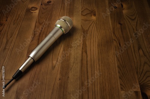 Photo: Microphone on wooden background Microphone on wooden background