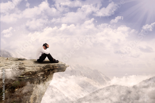 Photo: Businessman sitting on the edge Businessman sitting on the edge