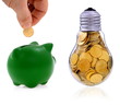 Traditional  lightbulb with  golden coins and green piggy bank