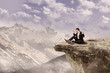Happy businessman on top of mountain