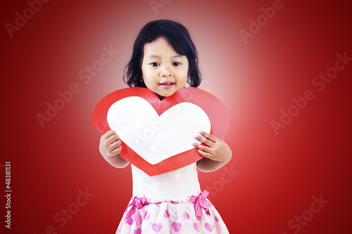 Photo: Girl with love heart card Girl with love heart card
