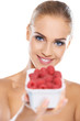 Beautiful woman with punnet of raspberries