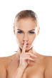 Woman making a shushing gesture