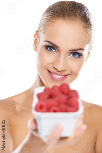 Photo: Beautiful woman with punnet of raspberries Beautiful woman with punnet of raspberries