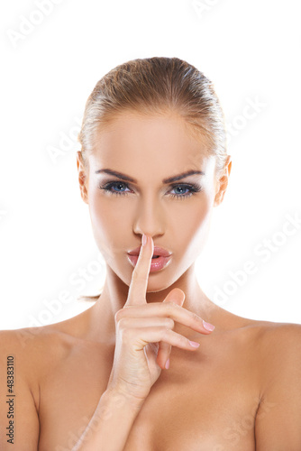 Photo: Woman making a shushing gesture Woman making a shushing gesture