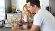 Video: Young couple using digital tablet at breakfast time Young couple using digital tablet at breakfast time