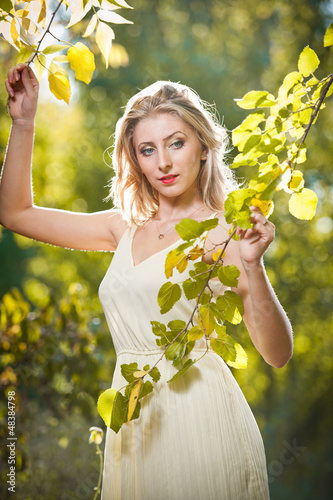 Photo: Young attractive woman in a romantic autumn scenery Young attractive woman in a romantic autumn scenery