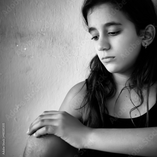 Photo: Hispanic girl with a very sad expression Hispanic girl with a very sad expression