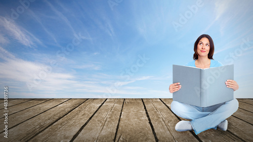 Photo: Young woman student reading the book. Young woman student reading the book.