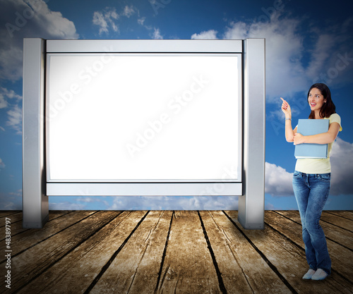 Photo: Student woman near billboard. Student woman near billboard.
