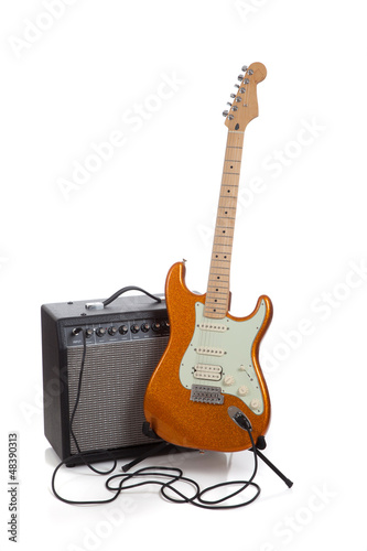 Photo: An amp and an electric guitar on a white background An amp and an electric guitar on a white background