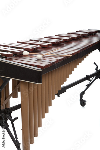 Photo: A brown wooden marimba on a white background A brown wooden marimba on a white background