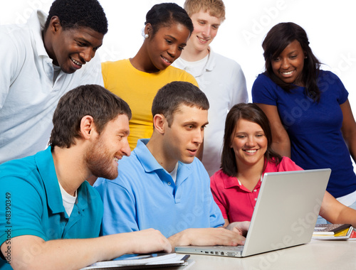 Photo: Diverse group of college students/friends looking at a computer Diverse group of college students/friends looking at a computer