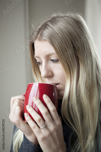 Photo: Young Woman Drinking Coffee Young Woman Drinking Coffee