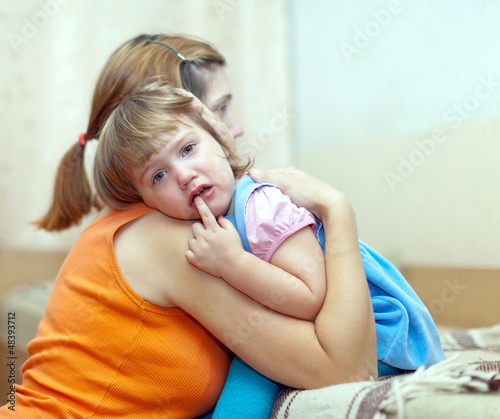 Photo: woman soothes crying child woman soothes crying child