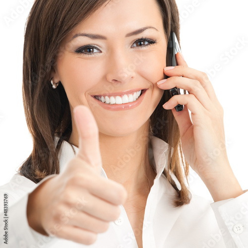 Photo: Businesswoman with cellphone and thumbs up Businesswoman with cellphone and thumbs up
