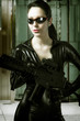 Caucasian beauty holding gun with business building in backgroun