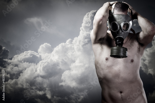 Photo: pollution concept: portrait of nude man in a gas mask pollution concept: portrait of nude man in a gas mask