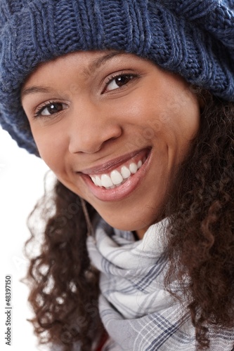 Photo: Closeup portrait of smiling afro woman in cap Closeup portrait of smiling afro woman in cap