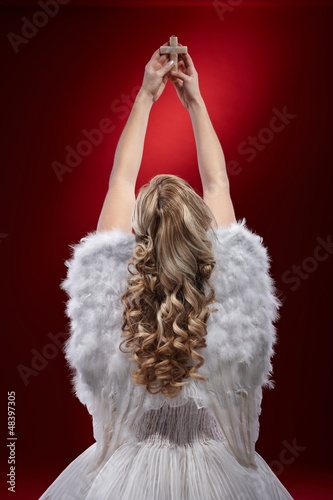 Photo: Angel praying holding crucifix Angel praying holding crucifix