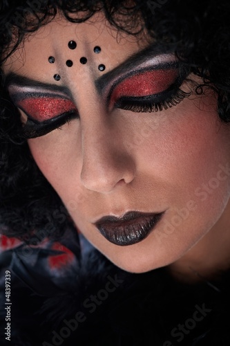 Photo: Closeup portrait of professional devil makeup Closeup portrait of professional devil makeup