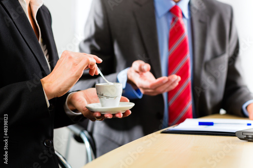 Photo: businesspeople in business office drink coffee businesspeople in business office drink coffee