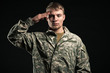 Military young man salutes. Studio portrait.